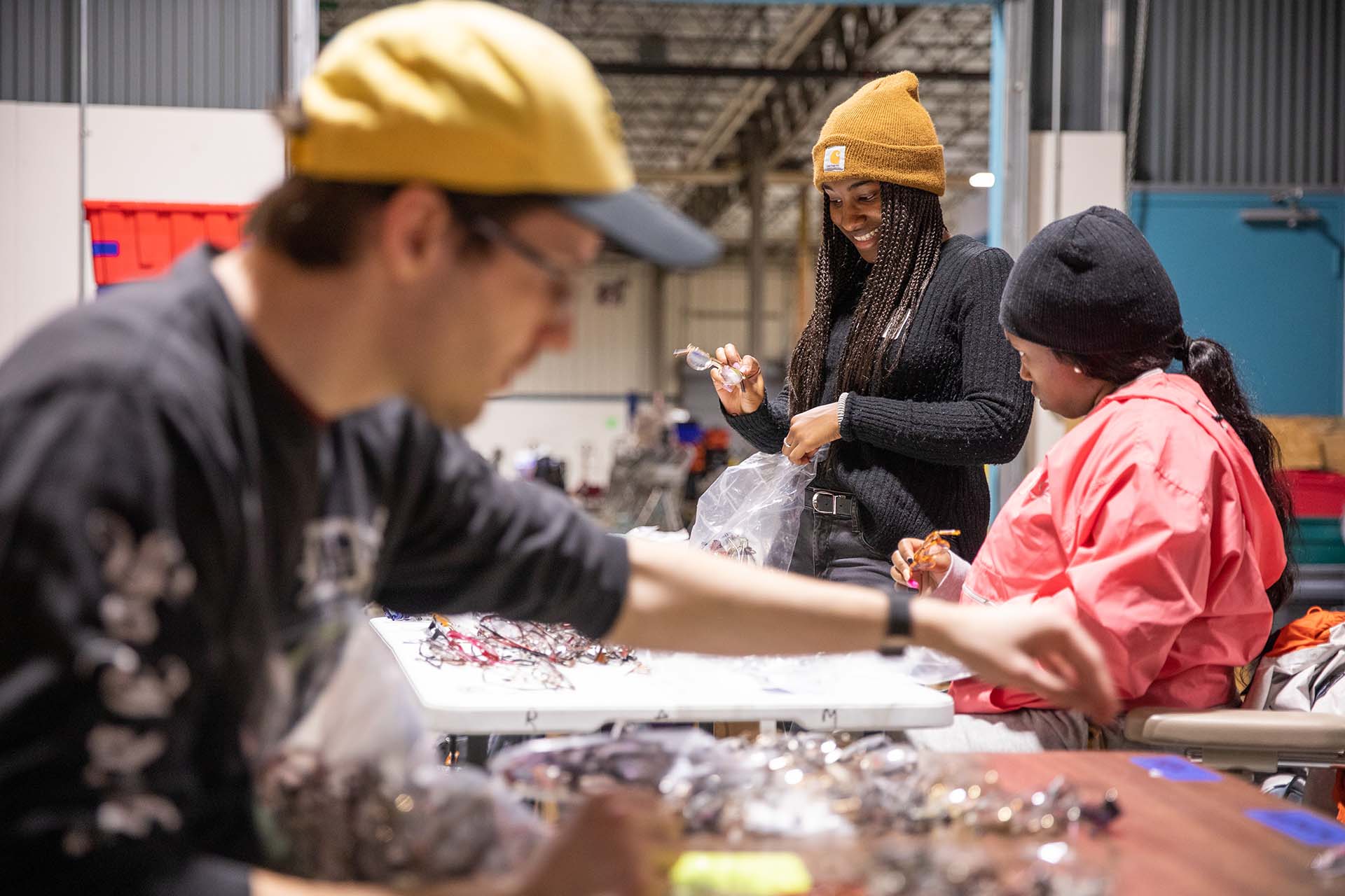 Students sort eye glasses during a MLK Day of Service