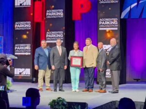 Six people on a stage accepting an award.